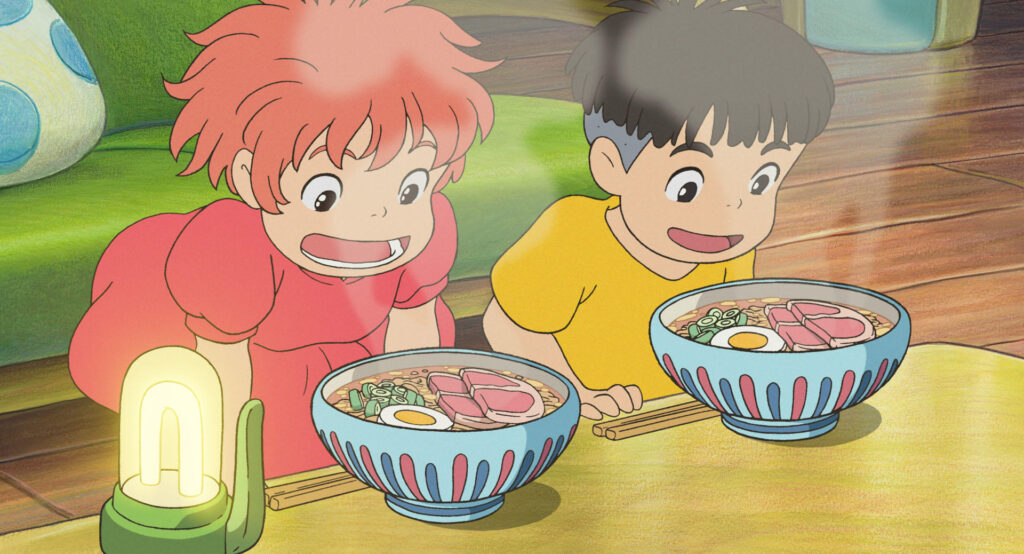 Two animated children eagerly look at two large bowls of ramen with eggs, meat, and vegetables on a table—capturing the warmth and charm found in Ghibli movies and reflecting treasured Japanese customs.