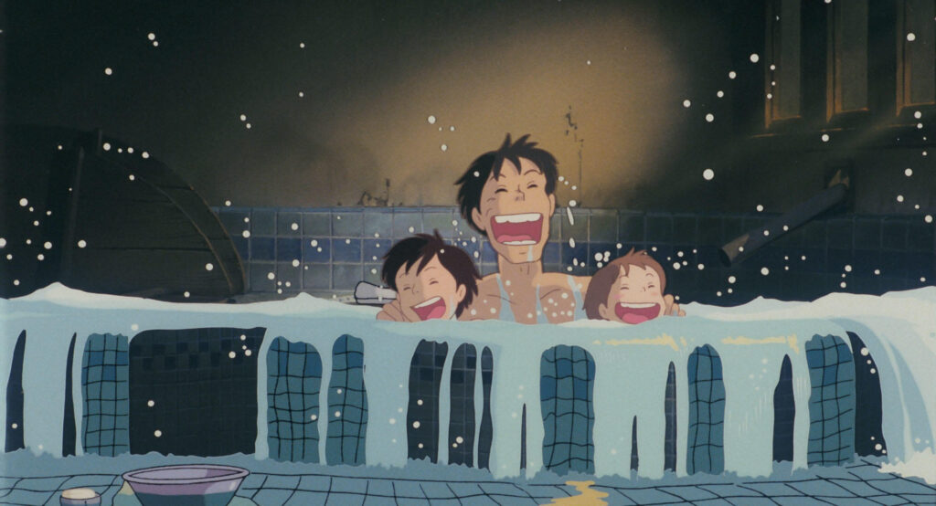 Bath scene from My Neighbor Totoro: Satsuki, Mei and their father are laughing together while taking a bath in a tiled tub, with bubbles and water splashing around.
