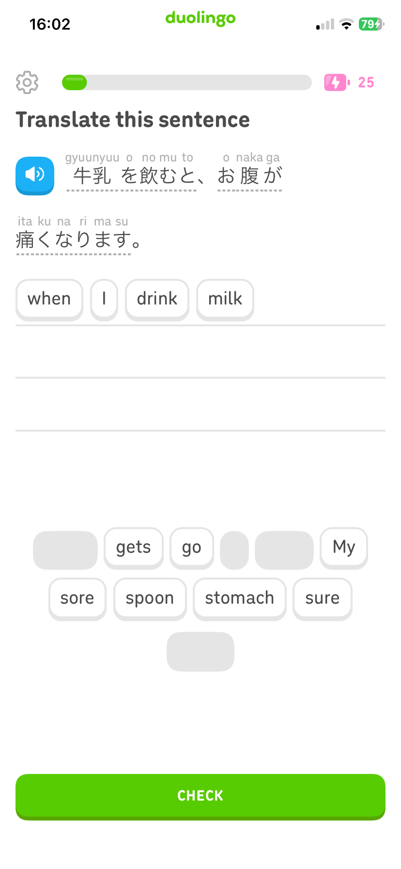 A Duolingo app screen—great for comparing japanesepod101 vs duolingo—asks the user to translate a Japanese sentence about drinking milk and having a sore stomach, using word tiles to create the answer.