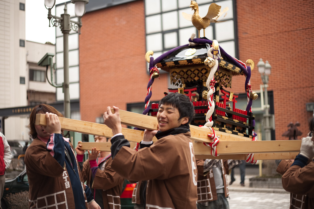 A group of people carry a decorative portable shrine on wooden beams during the traditional Japanese festival of Sanno Matsuri, held in Tokyo in June.
