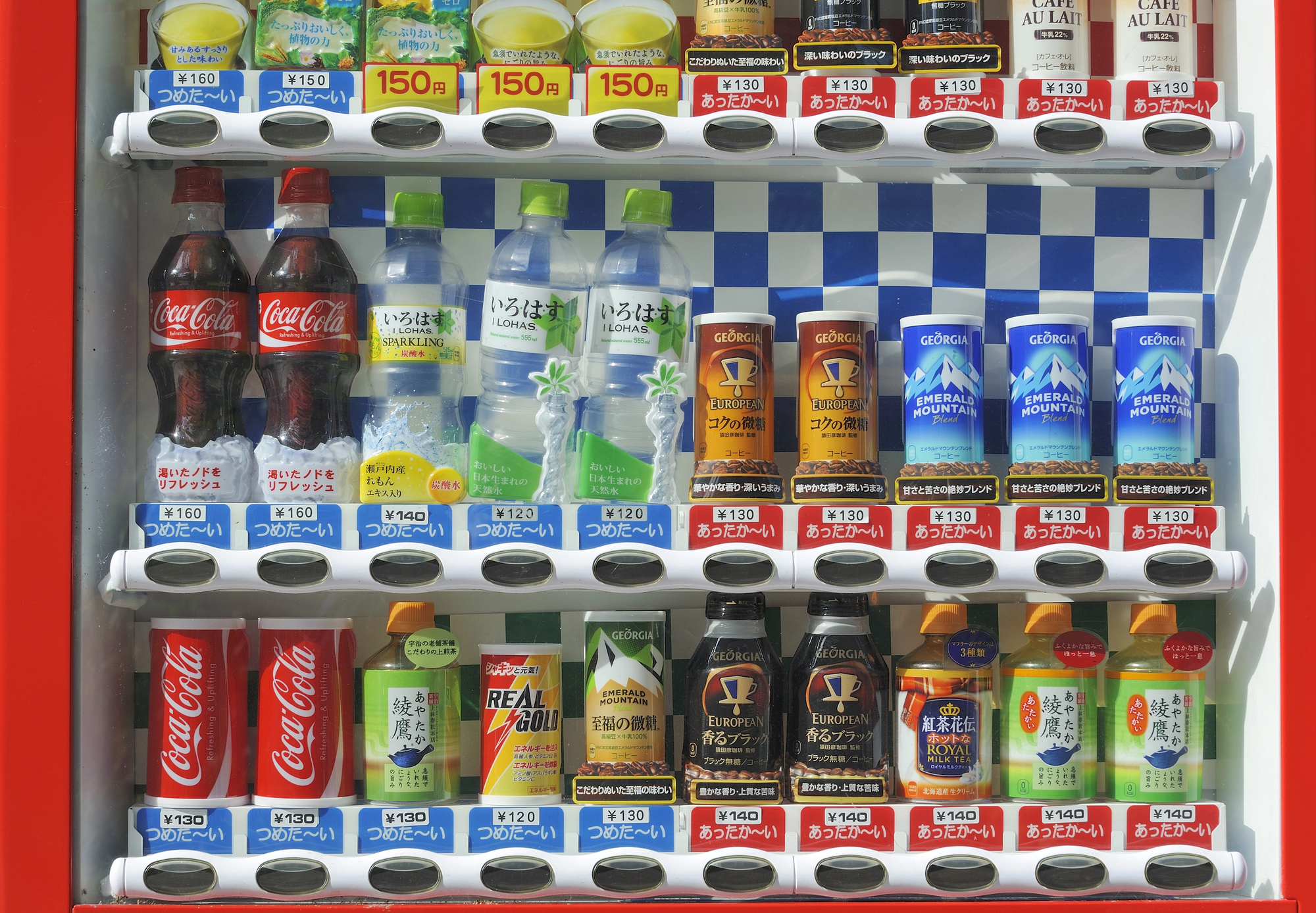 Japanese Vending Machine hot and cold drinks A Japanese vending machine stocked with various bottled and canned drinks, including sodas, water, tea, coffee, and energy drinks, with prices labeled below each item. Each is also labelled 'hot' (with a red label) or 'cold' (with a blue label).